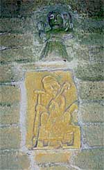 Small Norman figures over the south door of the church (A Nicholson, 2003).