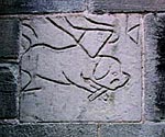 Carving of dog gnawing a bone (2003). 